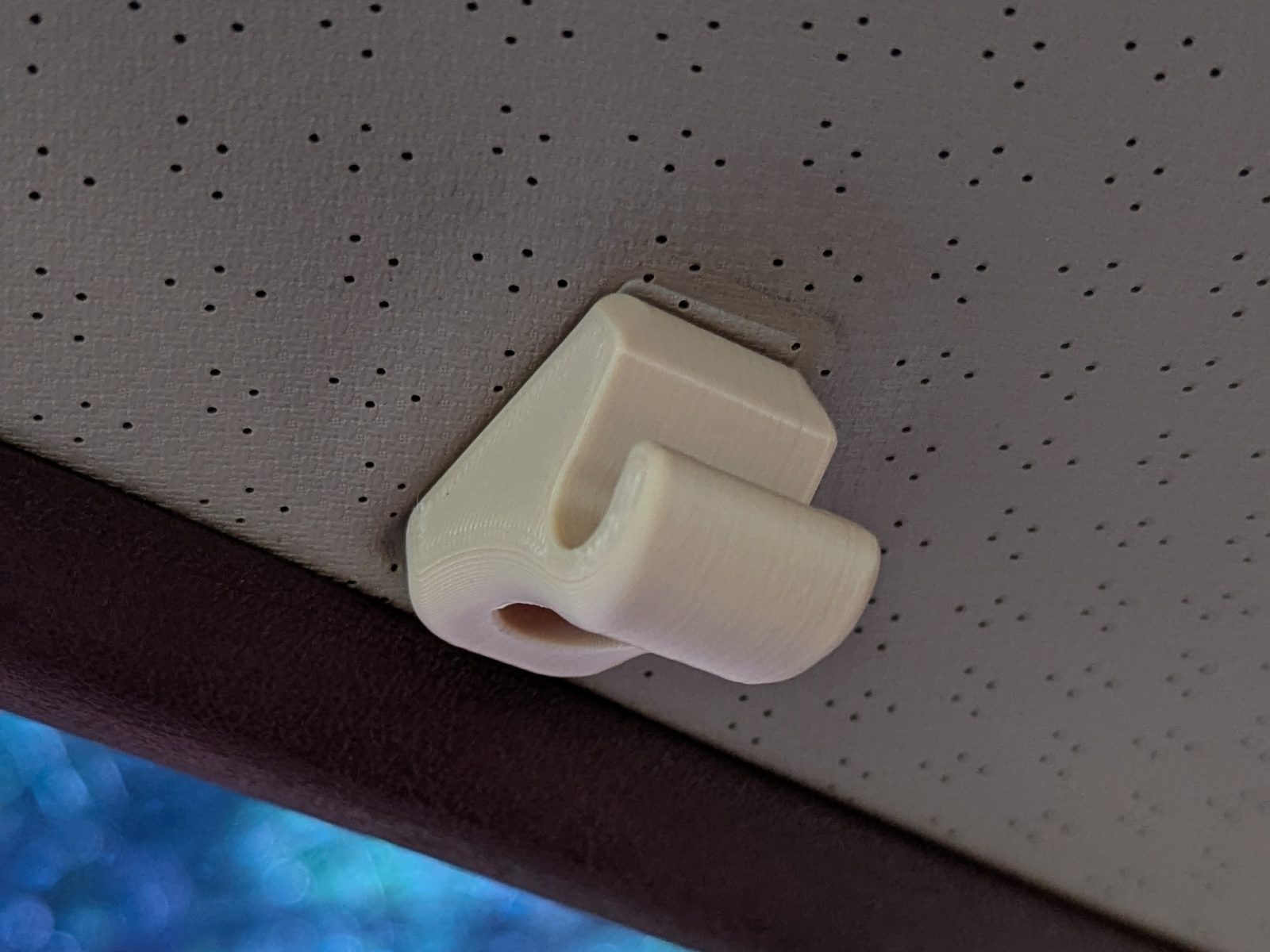 The final tan v12 visor clip installed on the headliner.