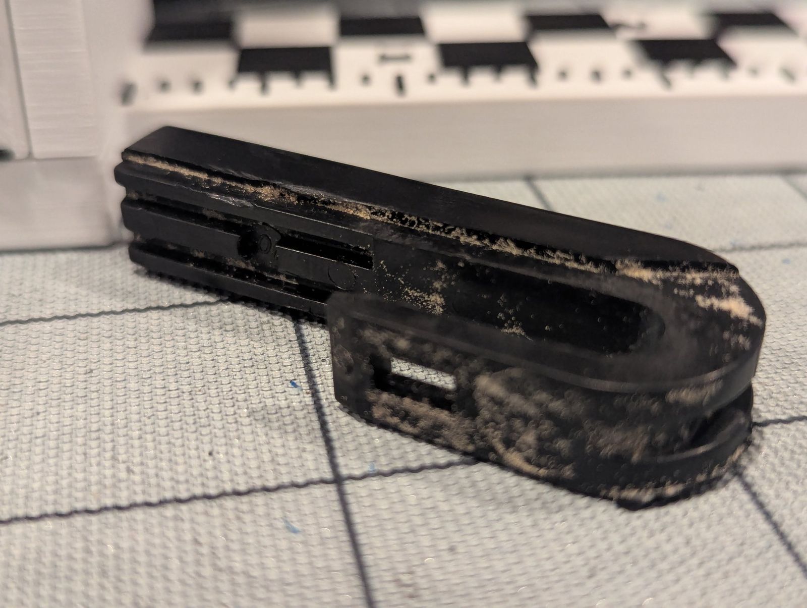 Close-up of the worn original rear wiper U-hook.
